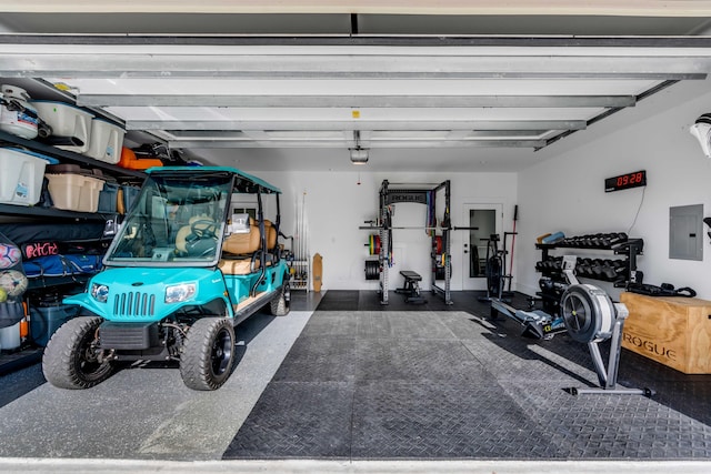 garage with a garage door opener and electric panel