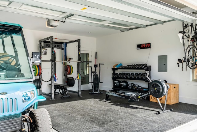 workout room with a garage, electric panel, and baseboards