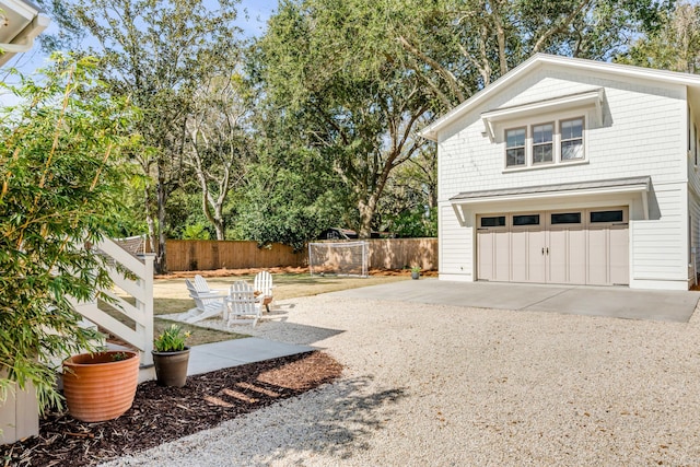 view of yard with a garage and fence