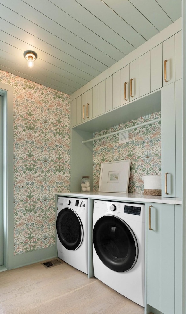926 Pitt St, Mount Pleasant, SC 29464 - washroom with wallpapered walls, washer and clothes dryer, cabinet space, baseboards, and light wood-style flooring