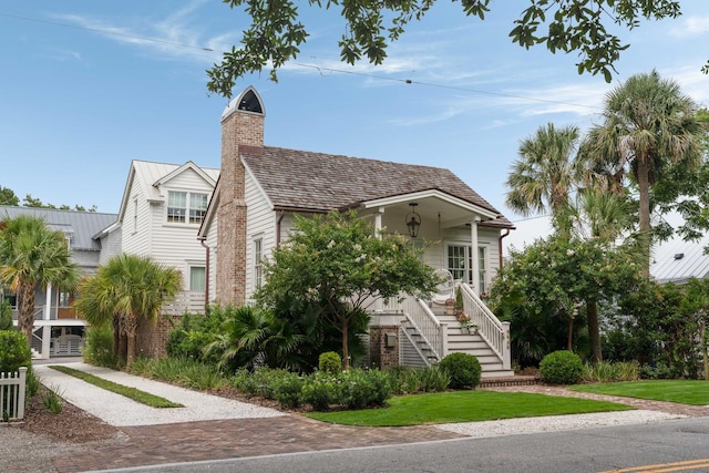926 Pitt St, Mount Pleasant, SC 29464 - view of front of house featuring stairs, a chimney, and brick siding