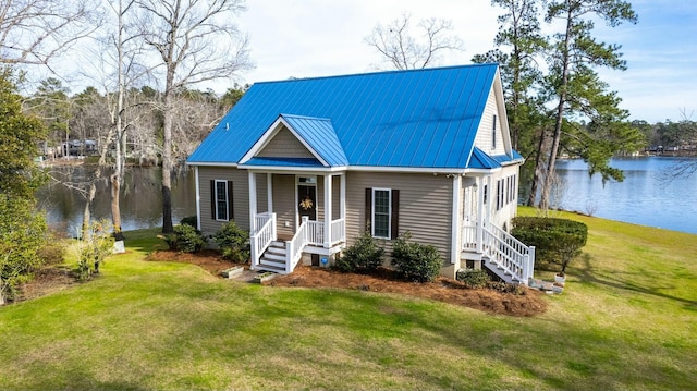 bungalow-style home featuring a front yard, a porch, a water view, and metal roof