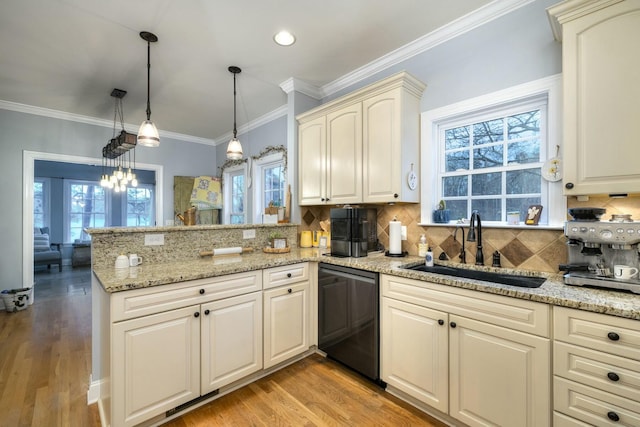 kitchen with dishwasher, light wood-type flooring, ornamental molding, a peninsula, and a sink