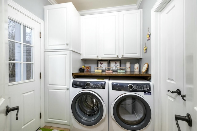 washroom with cabinet space and independent washer and dryer