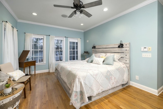 bedroom with recessed lighting, wood finished floors, baseboards, and ornamental molding