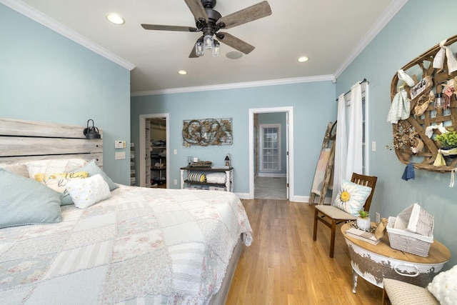 bedroom with a walk in closet, baseboards, ornamental molding, recessed lighting, and wood finished floors