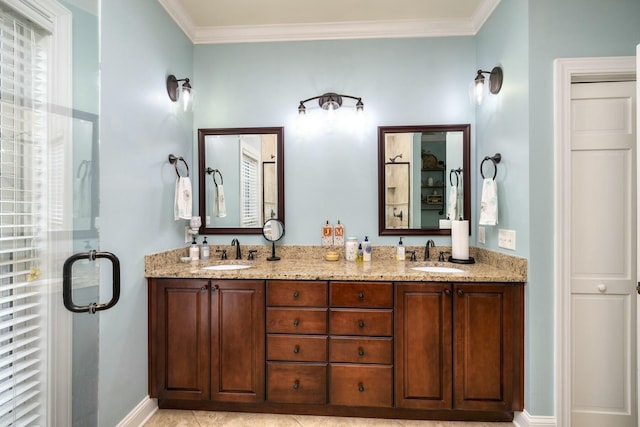 full bath featuring a sink, baseboards, double vanity, and crown molding