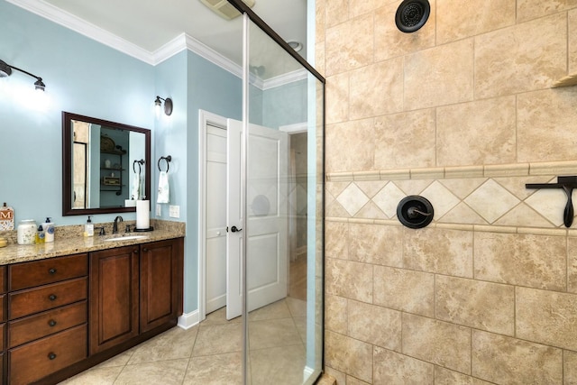 bathroom with tile patterned flooring, ornamental molding, vanity, and tiled shower