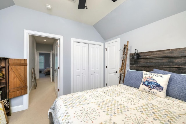 bedroom with light carpet, a ceiling fan, a closet, baseboards, and vaulted ceiling