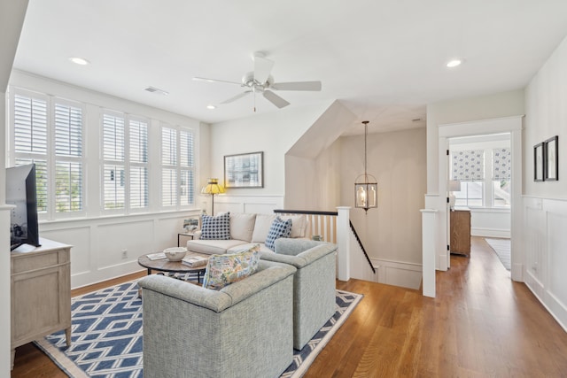 371 Bridgetown Pass, Mount Pleasant, SC 29464 - living room featuring a decorative wall, ceiling fan, wood finished floors, plenty of natural light, and wainscoting