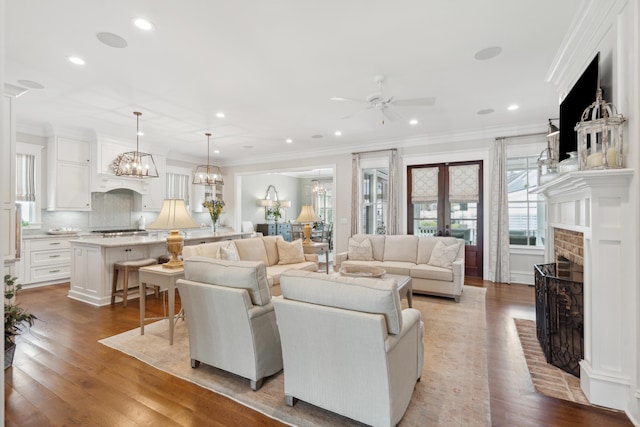 371 Bridgetown Pass, Mount Pleasant, SC 29464 - living room with a ceiling fan, hardwood / wood-style flooring, ornamental molding, a fireplace, and a chandelier