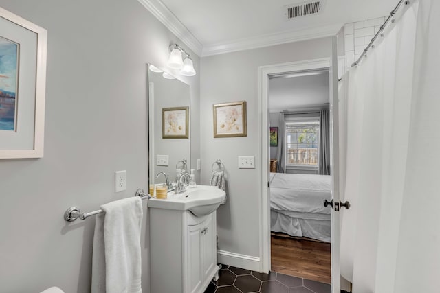 full bath featuring ensuite bathroom, tile patterned flooring, vanity, visible vents, and ornamental molding