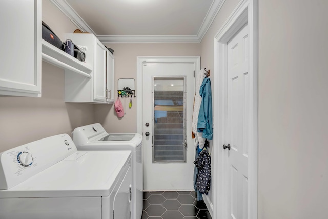 laundry room featuring cabinet space, crown molding, and washing machine and clothes dryer