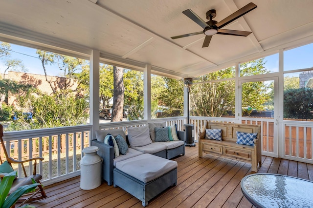 sunroom featuring ceiling fan