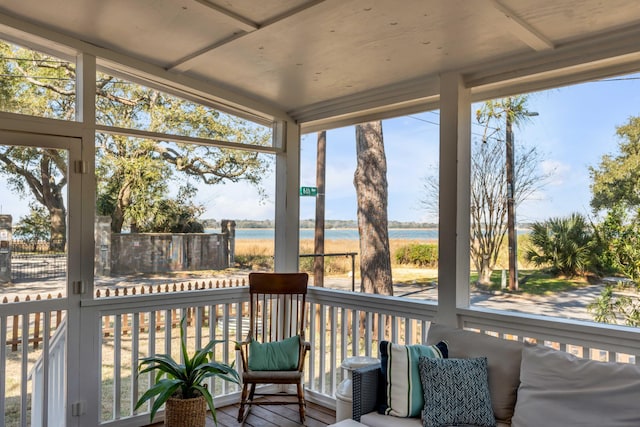 sunroom / solarium featuring a water view and a wealth of natural light