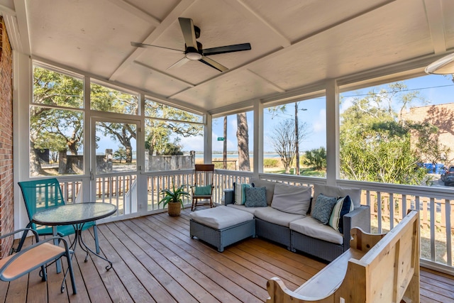 sunroom with a wealth of natural light and a ceiling fan