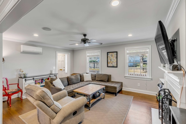 living area featuring baseboards, a fireplace with flush hearth, wood finished floors, a wall mounted air conditioner, and crown molding