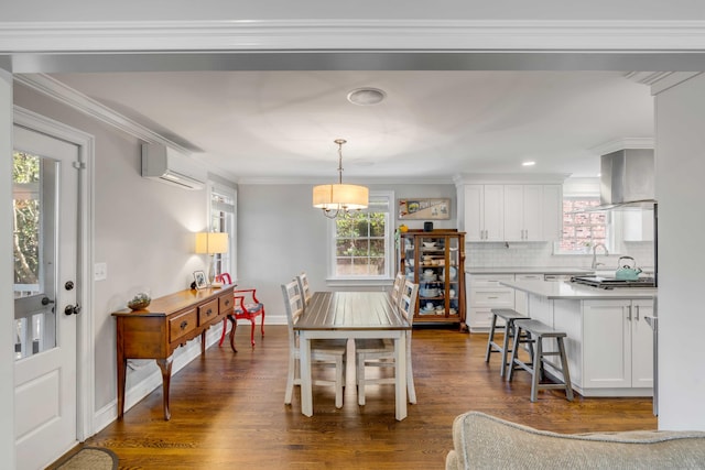 dining room with crown molding, baseboards, dark wood-type flooring, and an AC wall unit