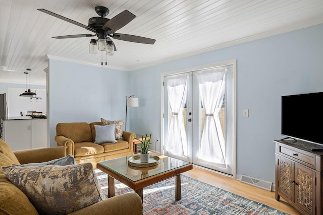 living room featuring ceiling fan, wood ceiling, crown molding, light wood-type flooring, and french doors