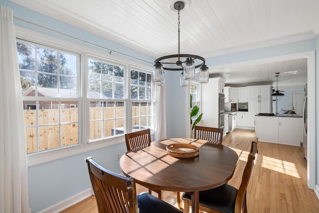 dining area featuring ornamental molding and light hardwood / wood-style floors