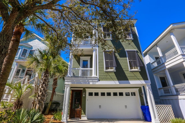 25 Ocean Point Dr, Isle Of Palms, SC 29451 - view of front of home with concrete driveway, an attached garage, and a balcony