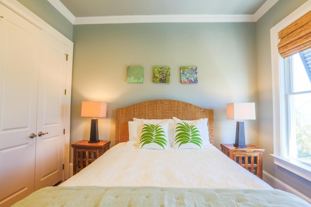 25 Ocean Point Dr, Isle Of Palms, SC 29451 - bedroom featuring ornamental molding, multiple windows, baseboards, and a closet