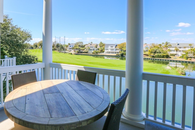 25 Ocean Point Dr, Isle Of Palms, SC 29451 - deck with outdoor dining area, a water view, a residential view, a lawn, and view of golf course