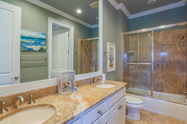 25 Ocean Point Dr, Isle Of Palms, SC 29451 - bathroom featuring toilet, double vanity, ornamental molding, and bath / shower combo with glass door