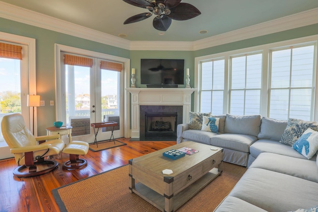 25 Ocean Point Dr, Isle Of Palms, SC 29451 - living room featuring a ceiling fan, a fireplace, wood finished floors, and crown molding