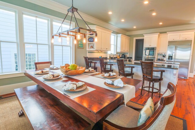 25 Ocean Point Dr, Isle Of Palms, SC 29451 - dining space with crown molding, light wood finished floors, recessed lighting, and baseboards