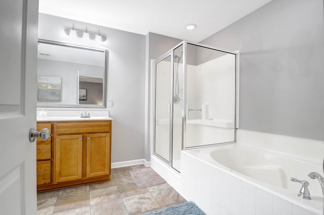 bathroom featuring vanity and plus walk in shower