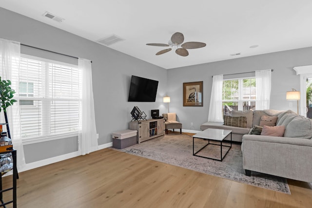 living room with ceiling fan and hardwood / wood-style floors