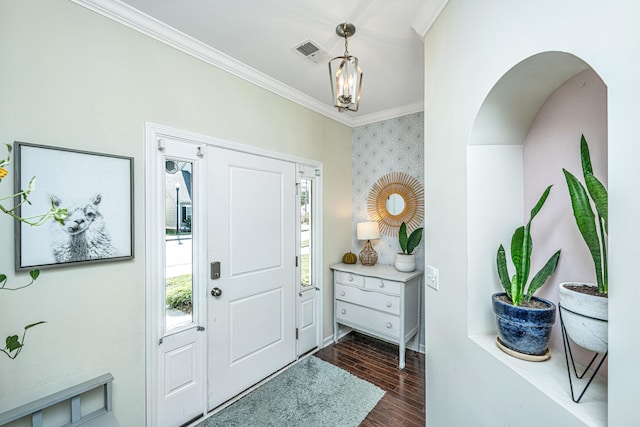 foyer with dark hardwood / wood-style floors and crown molding