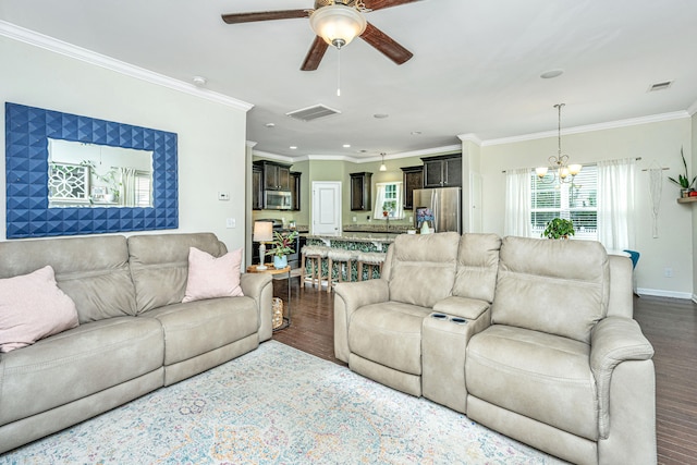 living room featuring ceiling fan with notable chandelier, dark hardwood / wood-style flooring, and ornamental molding