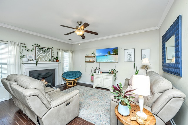 living room featuring dark hardwood / wood-style flooring, ceiling fan, and crown molding