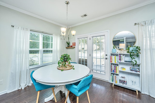 dining room featuring crown molding, a chandelier, and dark hardwood / wood-style floors