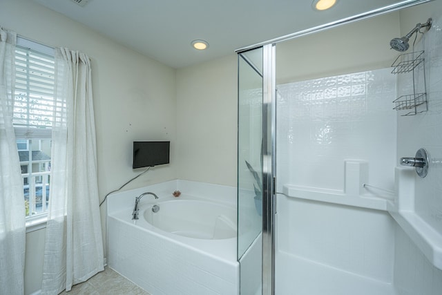 bathroom featuring separate shower and tub, a wealth of natural light, and tile patterned flooring