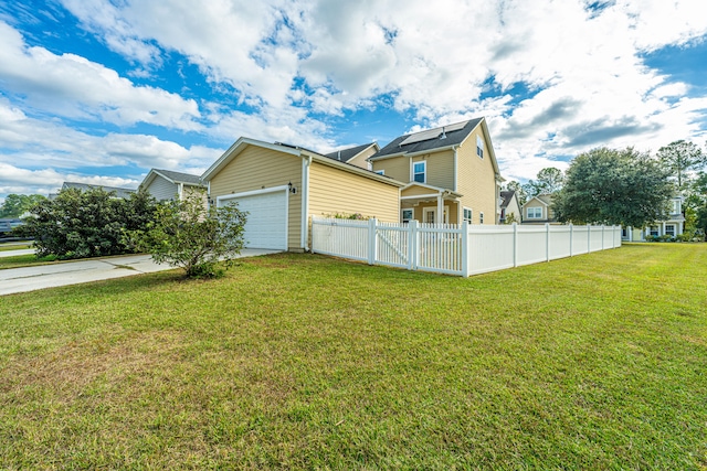 view of side of property featuring a lawn and a garage