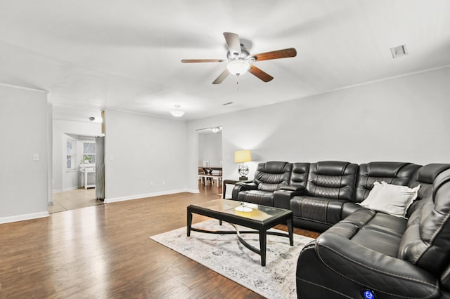 living room with ceiling fan, wood finished floors, and baseboards