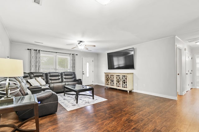 living room with crown molding, ceiling fan, baseboards, and wood finished floors
