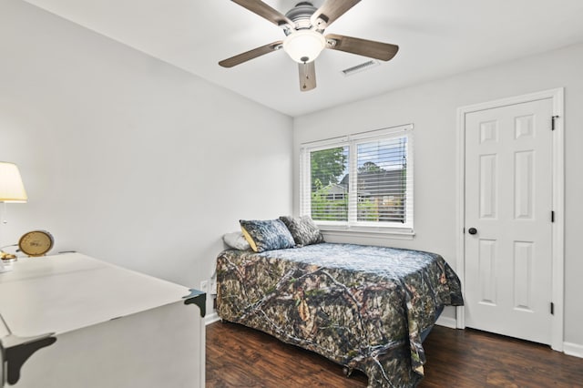 bedroom with wood finished floors, baseboards, and a ceiling fan