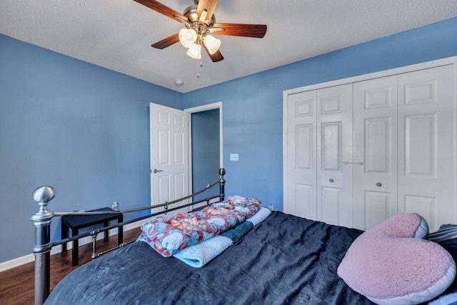 bedroom featuring dark hardwood / wood-style floors, a closet, and ceiling fan