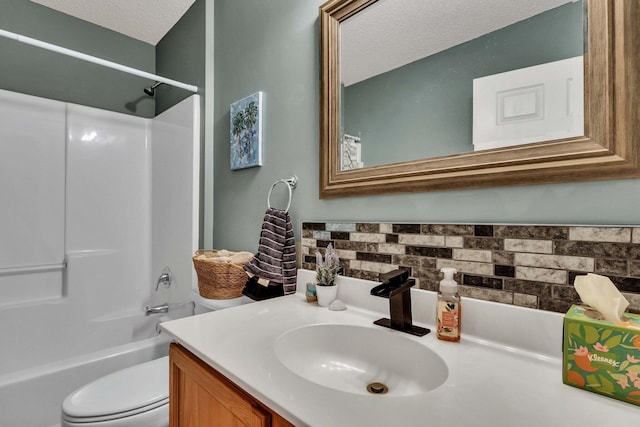 full bathroom featuring shower / tub combination, vanity, a textured ceiling, and toilet