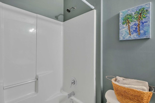 bathroom with shower / washtub combination and toilet