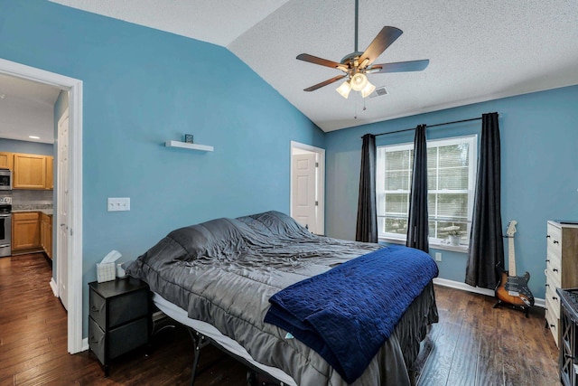 bedroom featuring a textured ceiling, vaulted ceiling, dark hardwood / wood-style floors, and ceiling fan