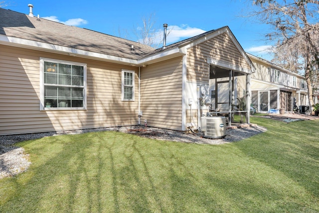 view of side of home with central air condition unit and a lawn