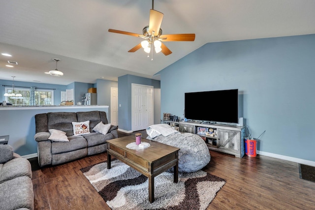 living room featuring dark wood-type flooring, ceiling fan, and vaulted ceiling