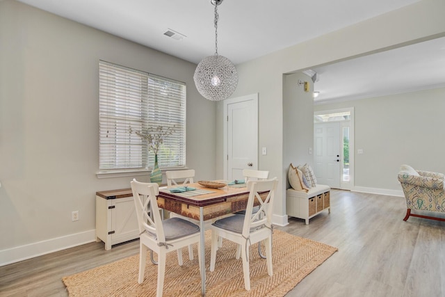 2404 Fulford Ct, Mount Pleasant, SC 29466 - dining space with light wood-type flooring and a chandelier