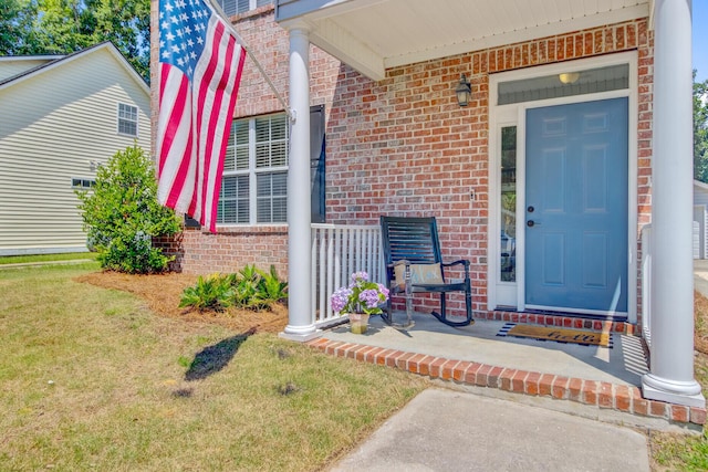 2404 Fulford Ct, Mount Pleasant, SC 29466 - property entrance with a porch, brick siding, and a yard