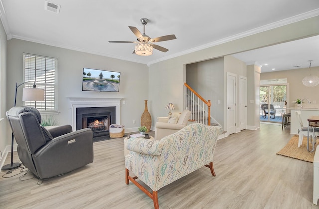 2404 Fulford Ct, Mount Pleasant, SC 29466 - living room featuring light wood finished floors, stairs, a ceiling fan, a fireplace with flush hearth, and ornamental molding